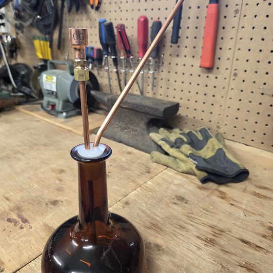 On the workbench where it is built, among the tools.