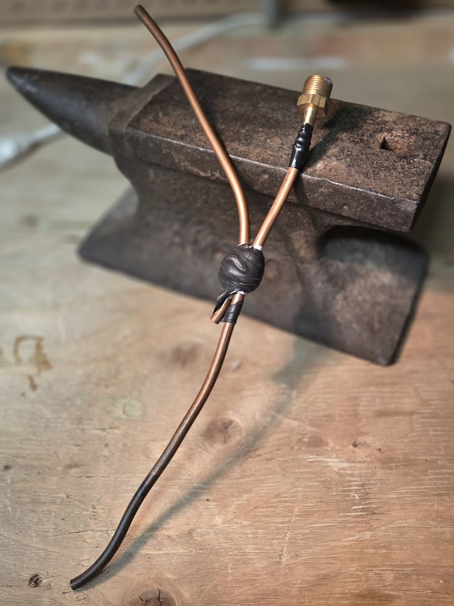 AJ's original prototype: copper tubing, a brass fitting, and a taped joint.